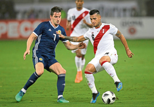 Peru's Miguel Trauco, right, fights for the ball with Scotland's Kenny McLean during a friendly soccer match in Lima, Peru, Tuesday, May 29, 2018. (AP Photo/Martin Mejia)