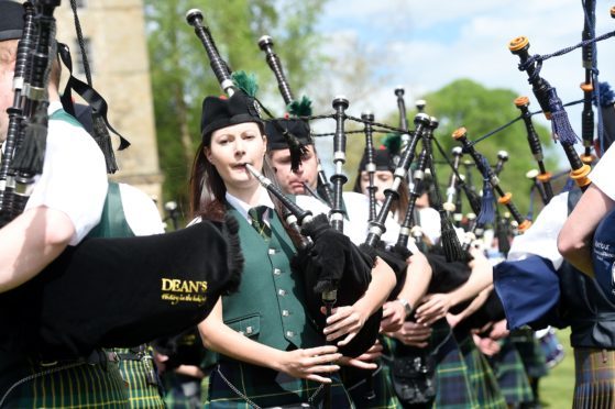 Gordon Castle Highland Games, Fochabers. The massed pipe bands perform for the crowds.
Picture by Sandy McCook.
