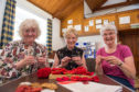 Mary Duncanson, Ethel Fowler and Anne Mathieson knit their poppies