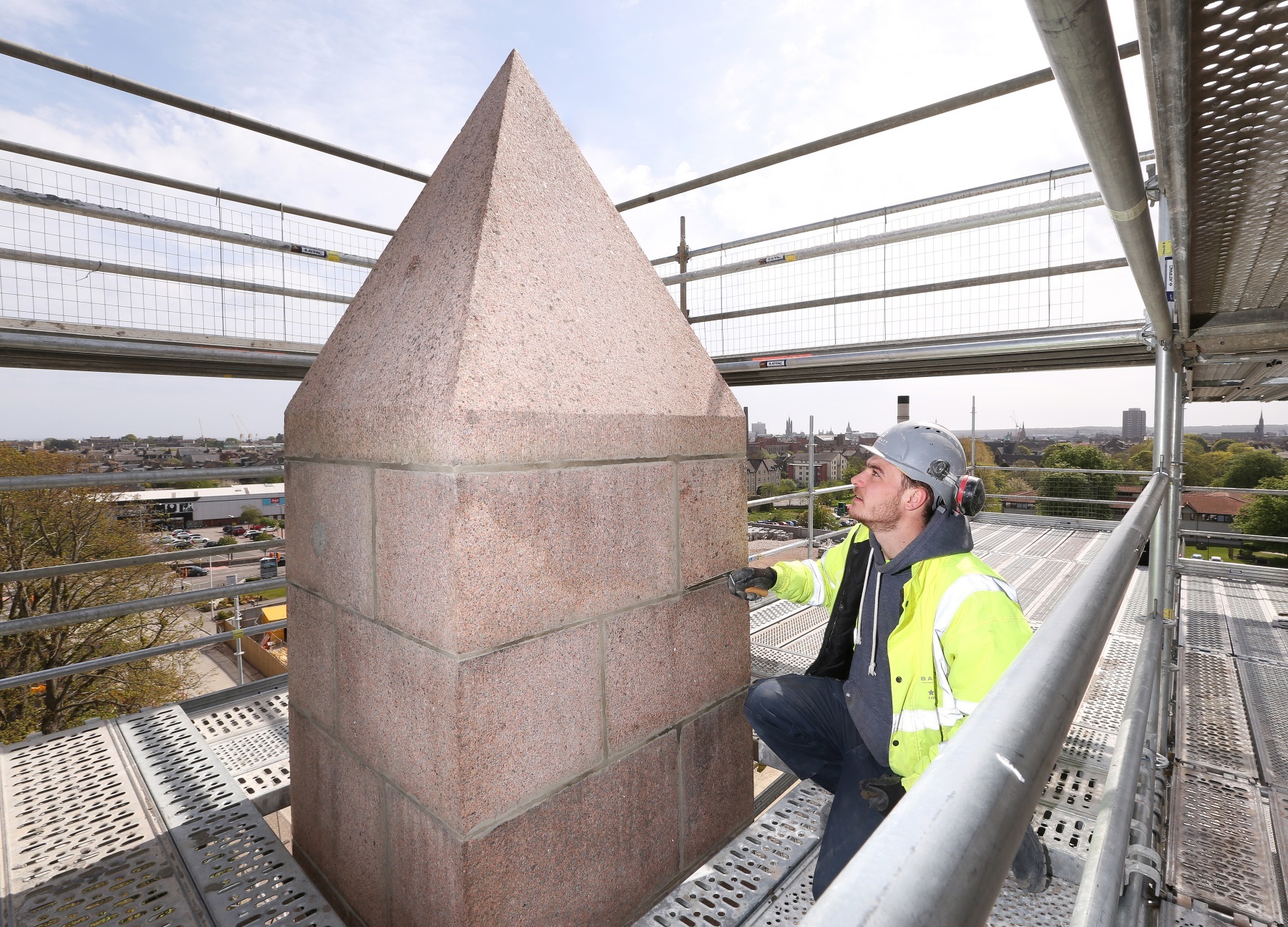 Barratt Homes worker Connor Higgins added the finishing touches to the top of the obelisk.