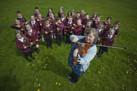 Millbank Primary School teacher Maureen Butterly and her entire class have been learning violin together
