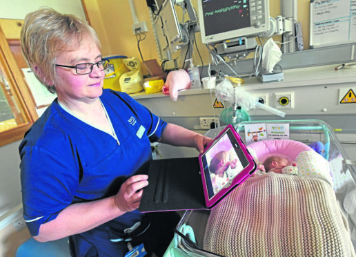 The Aberdeen maternity hospital are to intoduce, Vcreate with ipads for mums with their babies. In the picture are Susan Swinton, senior charge nurse with Lucy Ingram, 4 weeks old, Ellon.