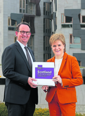 First Minister Nicola Sturgeon receives the Sustainable Growth Commission report from 
commission chairman Andrew Wilson. Ms Sturgeon has said it will “restart the debate” about independence