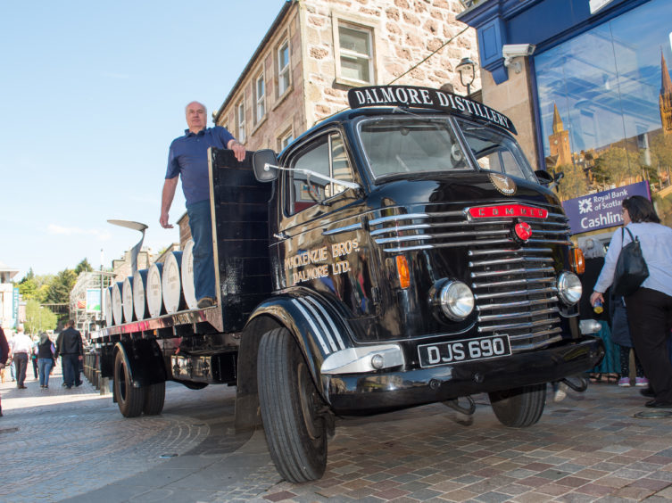 Employee, Iain Mcintosh from White and Makay Distillery with the distillery truck.