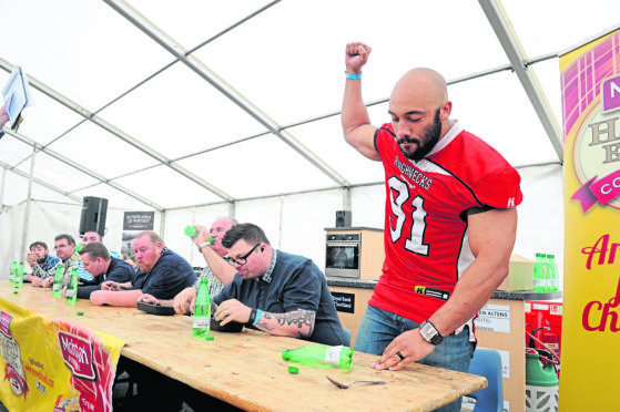 Richard Roach punches the air after winning the 2017 haggis-eating competition at the Thainstone Centre