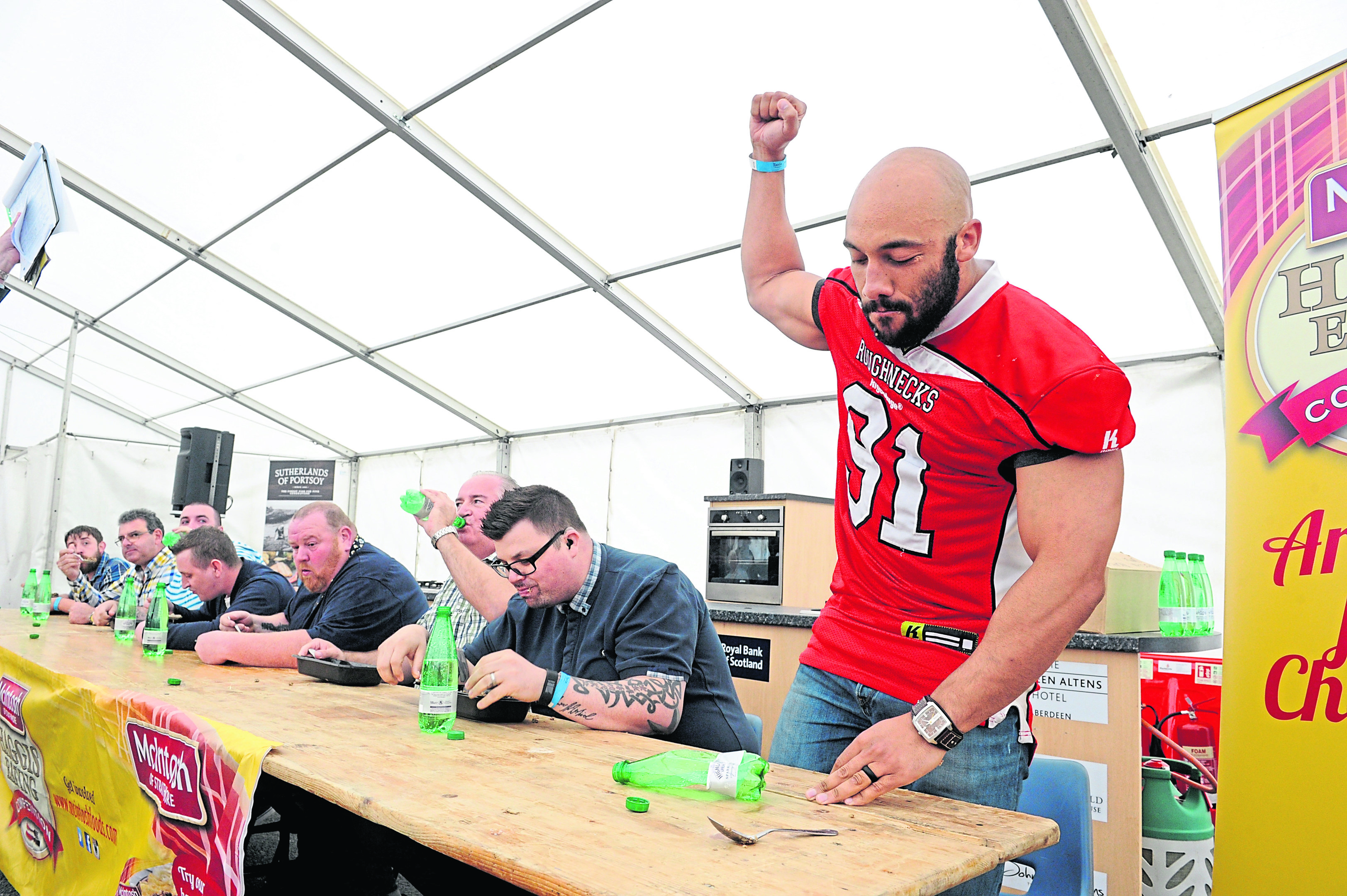 Richard Roach punches the air after winning the 2017 haggis-eating competition at the Thainstone Centre