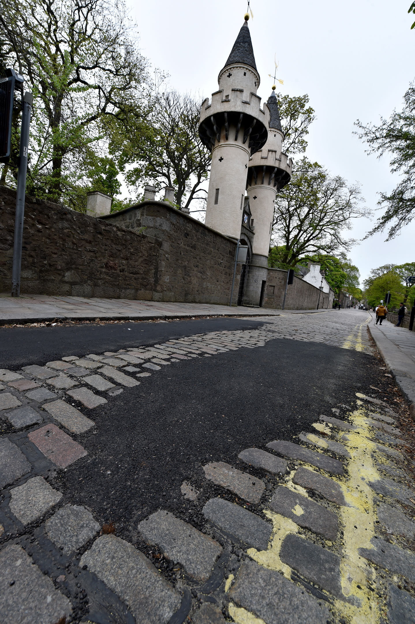 A stretch of tarmac has been laid over cobbles at the bus only entrance to University of Aberdeen