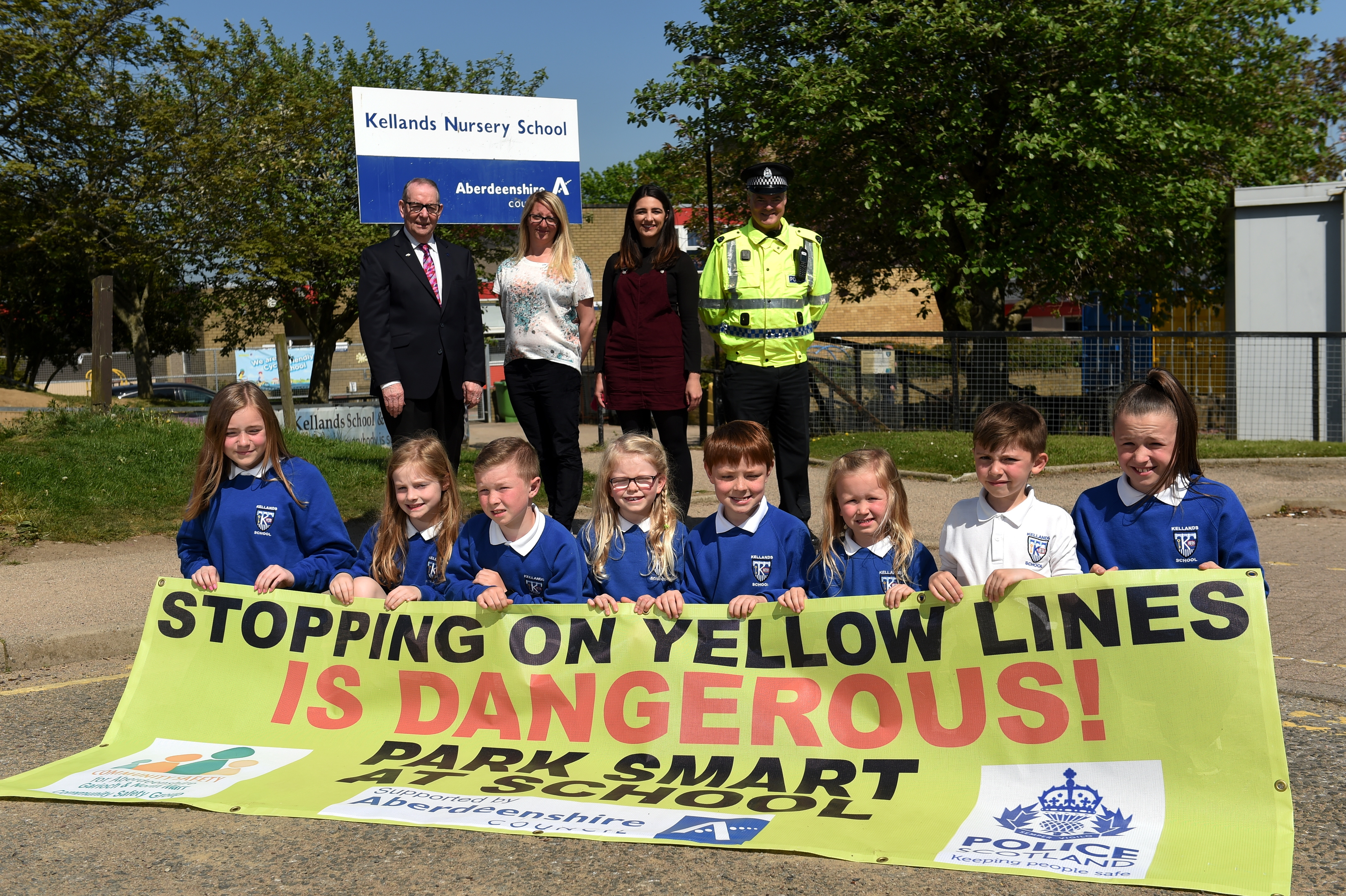 Colourful banners being displayed outside schools where there are parking problems.
Picture of (L-R) Ron McKail, Joanna Stewart, Sally Davis, PC Steve Middelton and pupils from Kellands School.

Picture by KENNY ELRICK     23/05/2018