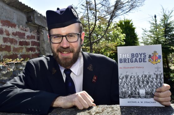 Michael Strachan with his illustrated history of the Boy's Brigade.