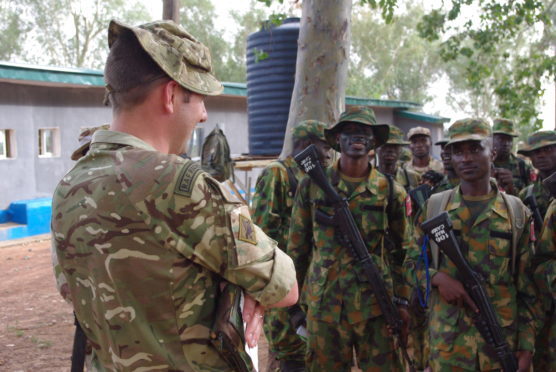 Corporal Thomas addresses the Nigerian troops.