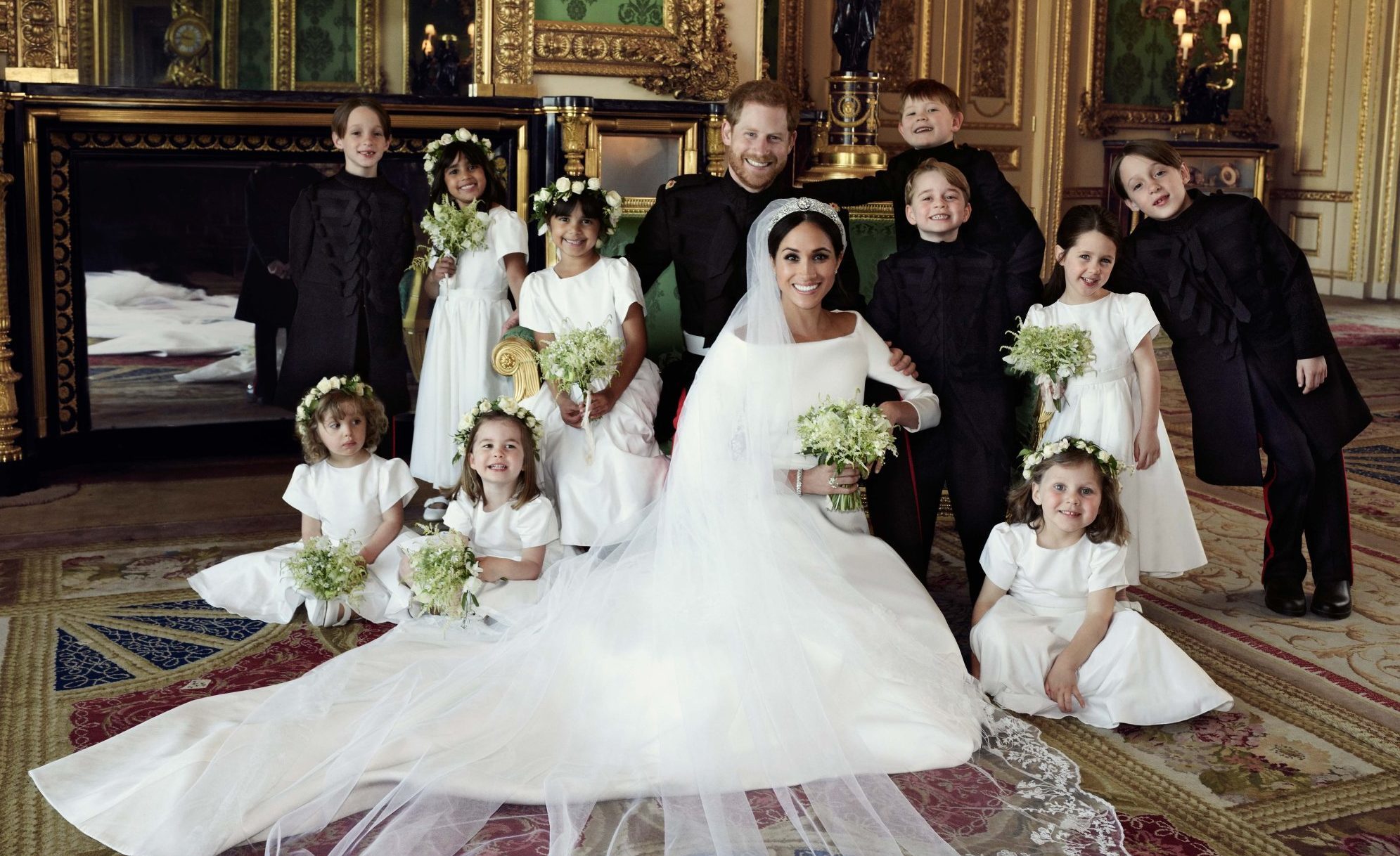 Prince Harry and Meghan Markle surrounded by bridesmaids and page boys after their wedding.