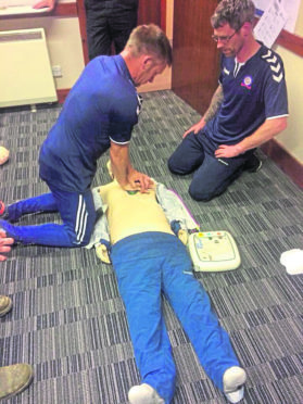 Coaches from Turriff United Youth FC receive life-saving skills training from fire service