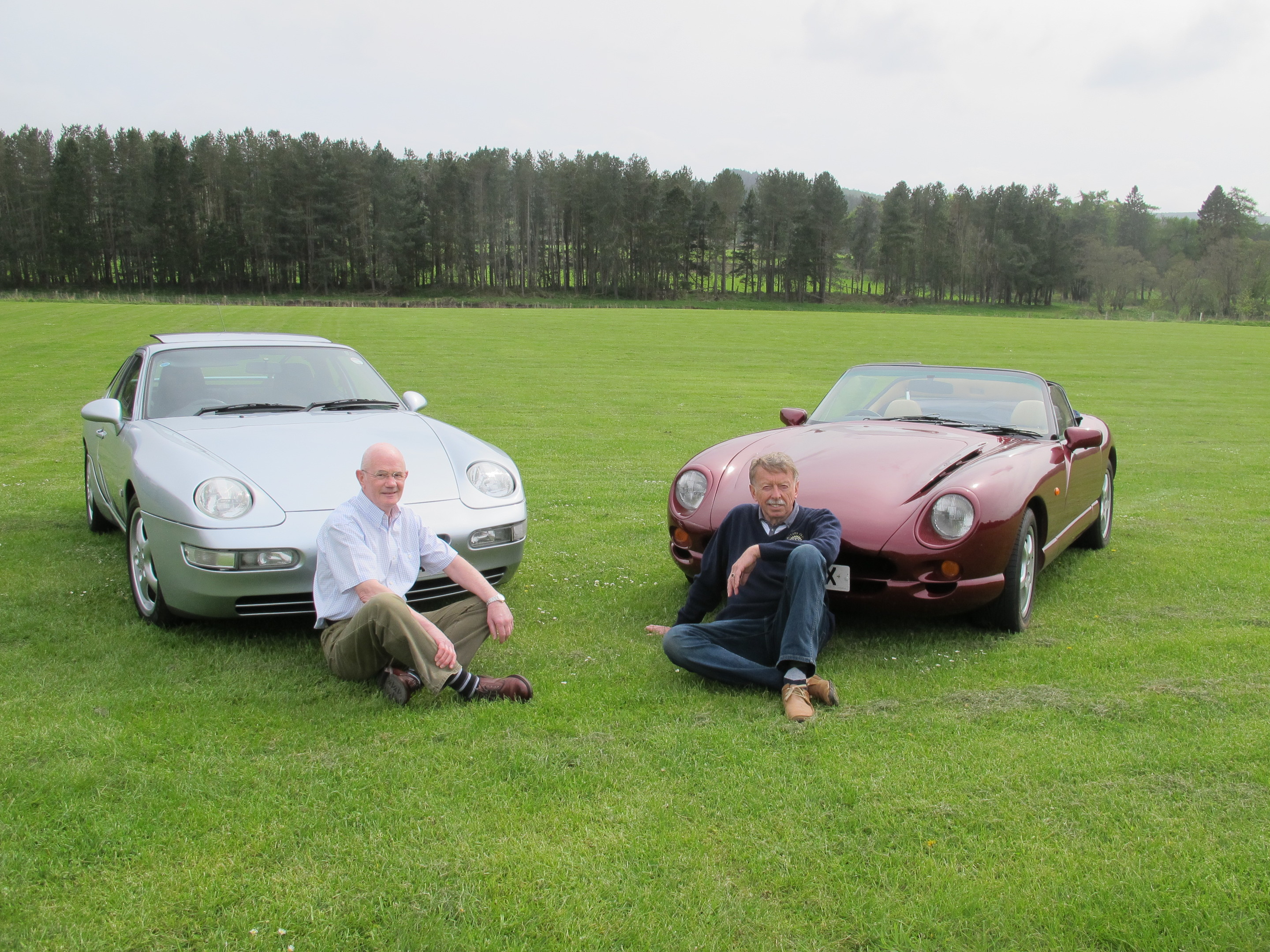Crathes Vintage Car Rally organising committee chairman Stewart Park, with his 1994 Porsche 968 Sport sits on the grass with past president Richard Bridger and his TVR Chimacra 450