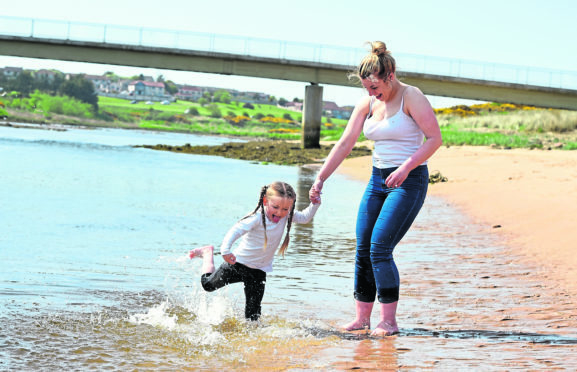 Ava Coutts, 4, and Stacia Wallace enjoy the fine weather