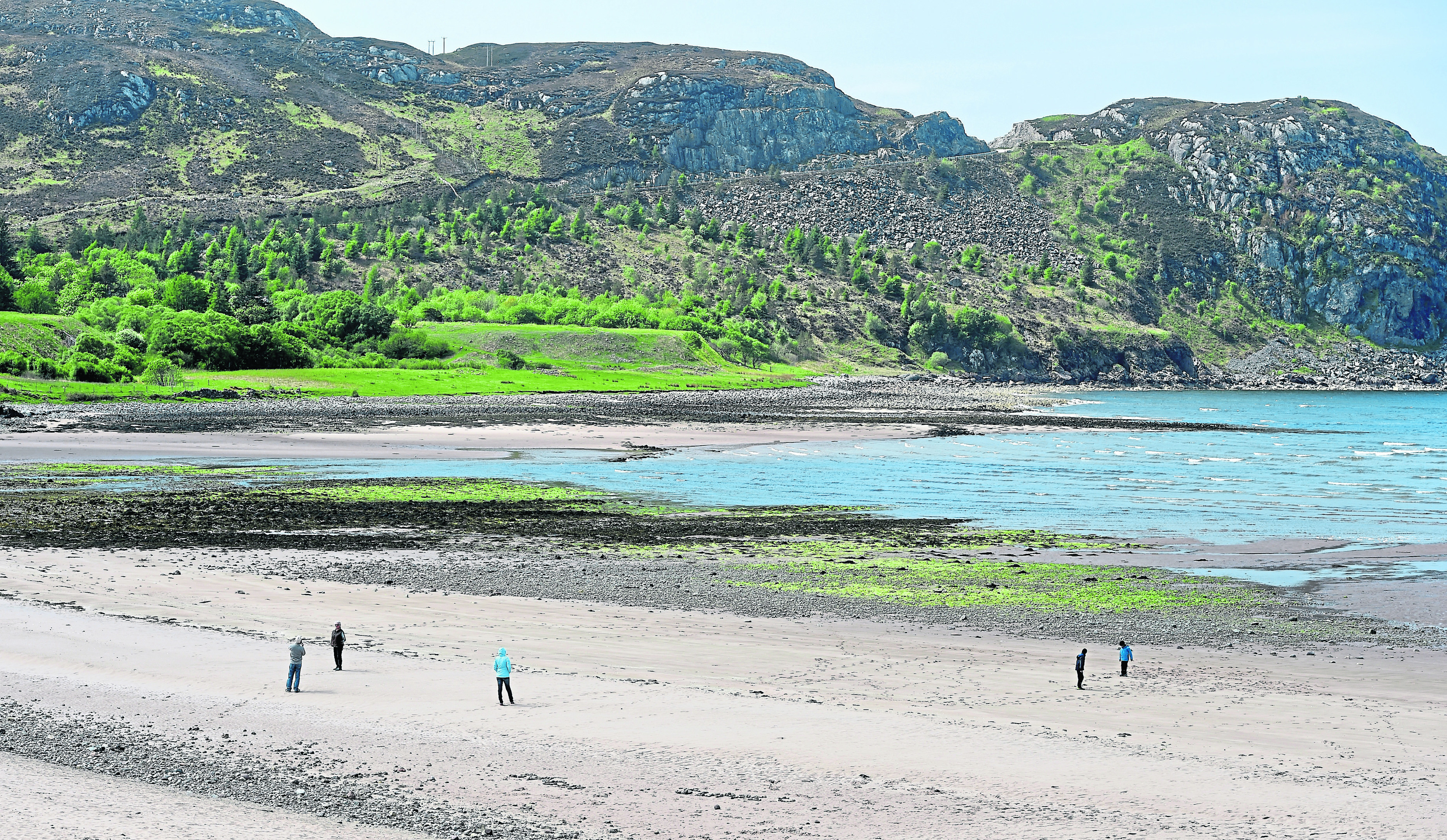 Walkers enjoy the warm weather while exploring Gruinard Bay in Wester Ross.