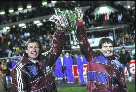 Aberdeen assistant manager Archie Knox (right) with manager Alex Ferguson with the European cup Winners cup after Aberdeen beat Real Madrid 2-1.