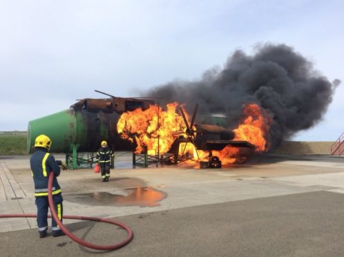 Firefighters in action at  Kirkwall Airport.
