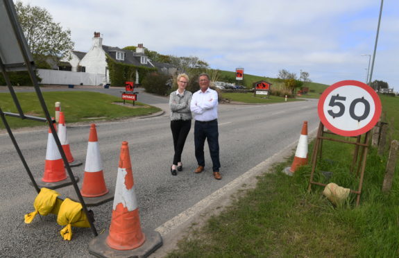 Pictured are Mandy Davidson a director of the Cock and Bull and Rodger Morrison the owner having a chat on the old A90 by the restaurant.
The restaurant is losing £700 a day and the AWPR are not putting signage up  to the restaurant.
Pic by Chris Sumner
23/5/18