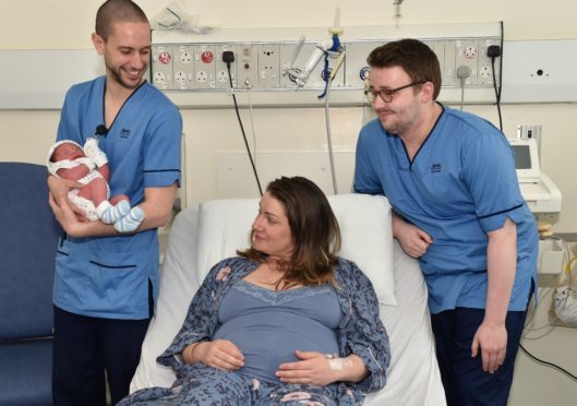 ARI has two male midwifes. They want to show it isnt just a job for women. Iain Macaulay (wearing glasses) and Miguel Angel Del Fresno with Baby Dominic and mum Veronica Tomozei.
Picture by COLIN RENNIE May 2, 2018.