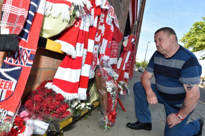 Lifelong Aberdeen FC fan David Paterson reflects as he looks at the Neale Cooper tributes. Picture by Colin Rennie.