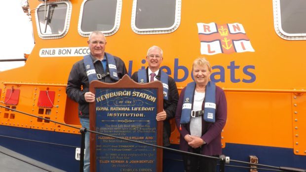 Keith Webb (centre) presents a Newvburgh-on-Ythan Lifeboat Station service board dated 1889 to Bill Deans (left), Aberdeen Lifeboat operations manager and Bec Allen (right), honorary secretary of Aberdeen branch, RNLI