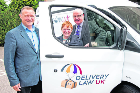 Drew Hendry, left, and councillors Margaret Davidson and Alister MacKinnon at the launch of the delivery charges website