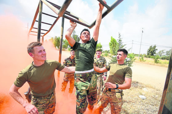 The Peshmerga are put through the Benswala training area by Corporal Hayden Cook from Carluke and 2nd Lieutenant Alex Toomey from Stirling.