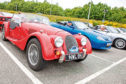 Classic cars line up before the start of the event