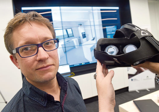 Matt Stevenson of Carbon Dynamic, based in Invergordon with the virtual reality version of a home they are developing for Albyn Housing.  The event was held yesterday at the HIE enterprise and research facility on the UHI Campus.
Picture by Sandy McCook