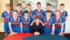 John Robertson with the 10 youngsters that signed their first professional deals with Caley Thistle.