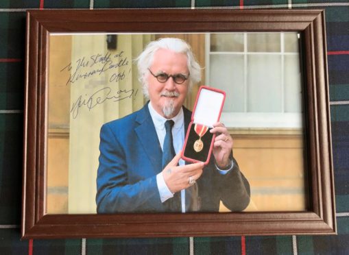 A framed photo left by comedian Billy Connolly after his stay at Kincraig Castle Hotel.