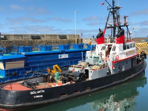 The seaman in his 70s was trapped between the tug Goliath and the blue fish farm feeder at Macduff