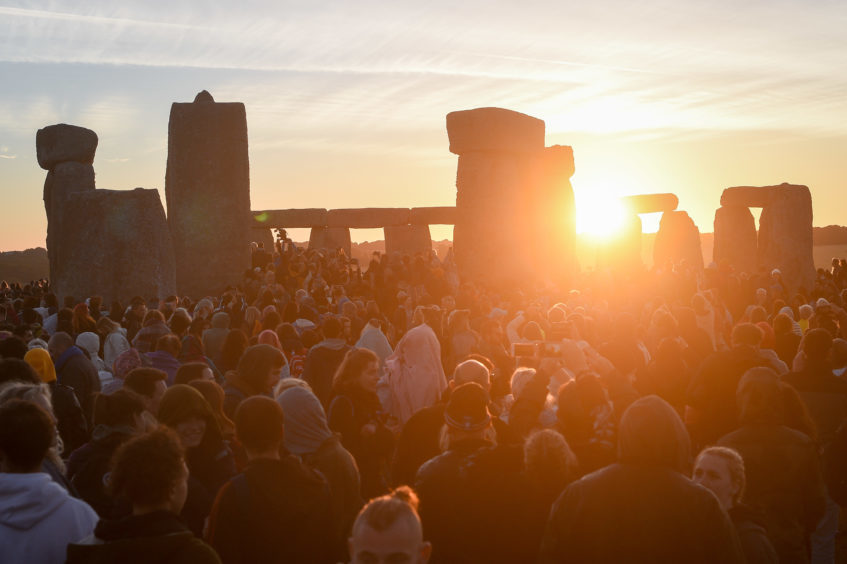 The sun breaks the horizon and shines through the stones at Stonehenge. Picture: Ben Birchall/PA Wire