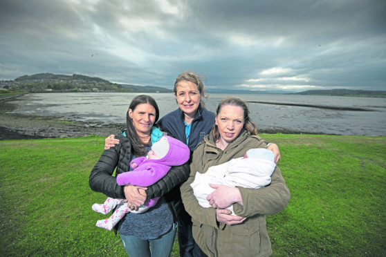 Midwife Hazel Inglis with two mums.