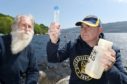 Professor Neil Gemmell of the University of Otago, New Zealand and Adrian Shine of the Loch Ness Project with water samples containing DNA which might lead to the discovery of Nessie