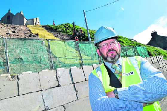 Councillor Mark Findlater at the Gardenstown landslip.