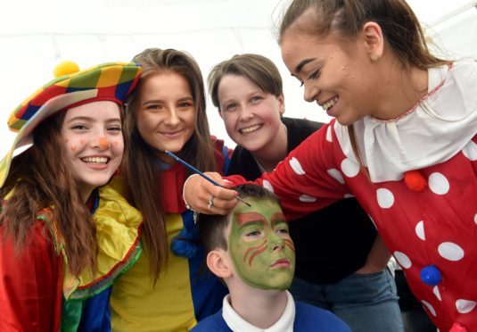 Rotary KidsOut was held at Craibstone. Declan Taylor 11 gets his face painted by (from left) Leire Hernandez, Heather Bowie, Cara Fyfe and Katie McDougall.
Picture by COLIN RENNIE  June 13, 2018.