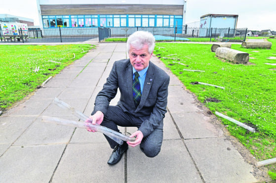 Councillor Alan Fakley at Clerkhil School where over two dozen newly planted trees have been ripped out by vandals.