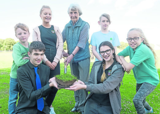 Adrianne Meikle cuts the turf with, from left, Rhyce Ashcroft, Harley Lea, Nadia McGuinnes, Corey Bell, Beth Ferguson and Lily Skinner. Photograph by Sandy McCook