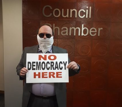 Peterhead councillor Alan Buchan staged a protest
