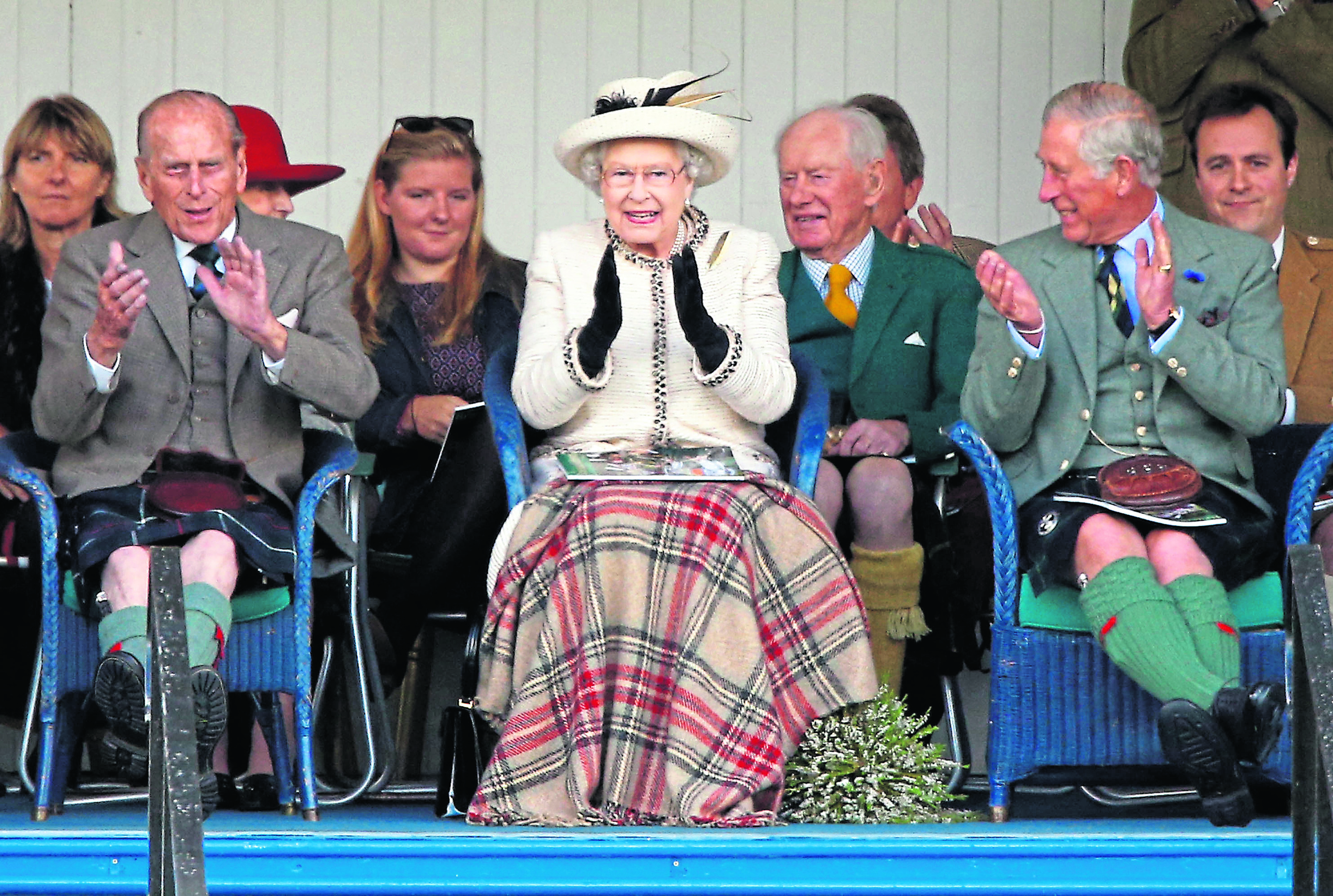 Prince Philip, Queen Elizabeth and Prince Charles regularly attend Highland Games, and here applaud the games at the Braemar Highland Gathering
