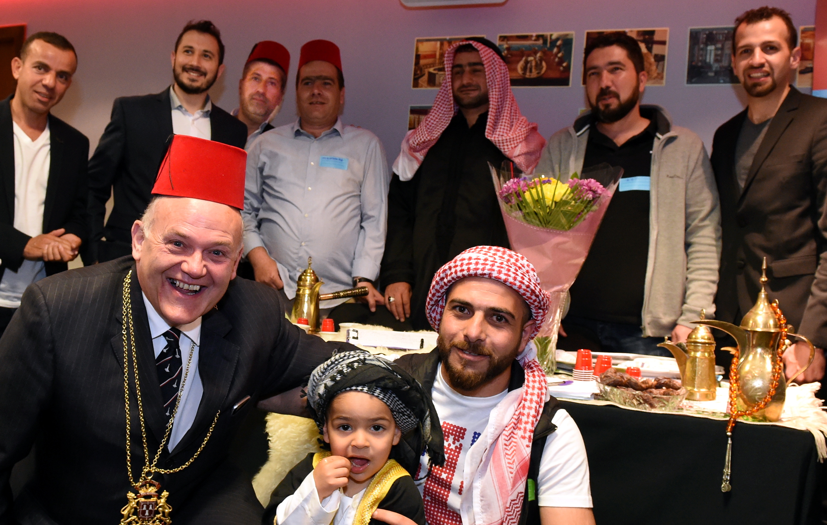 In the picture are Lord Provost Barney Crockett with Syrian people who hope to open a cafe in the city