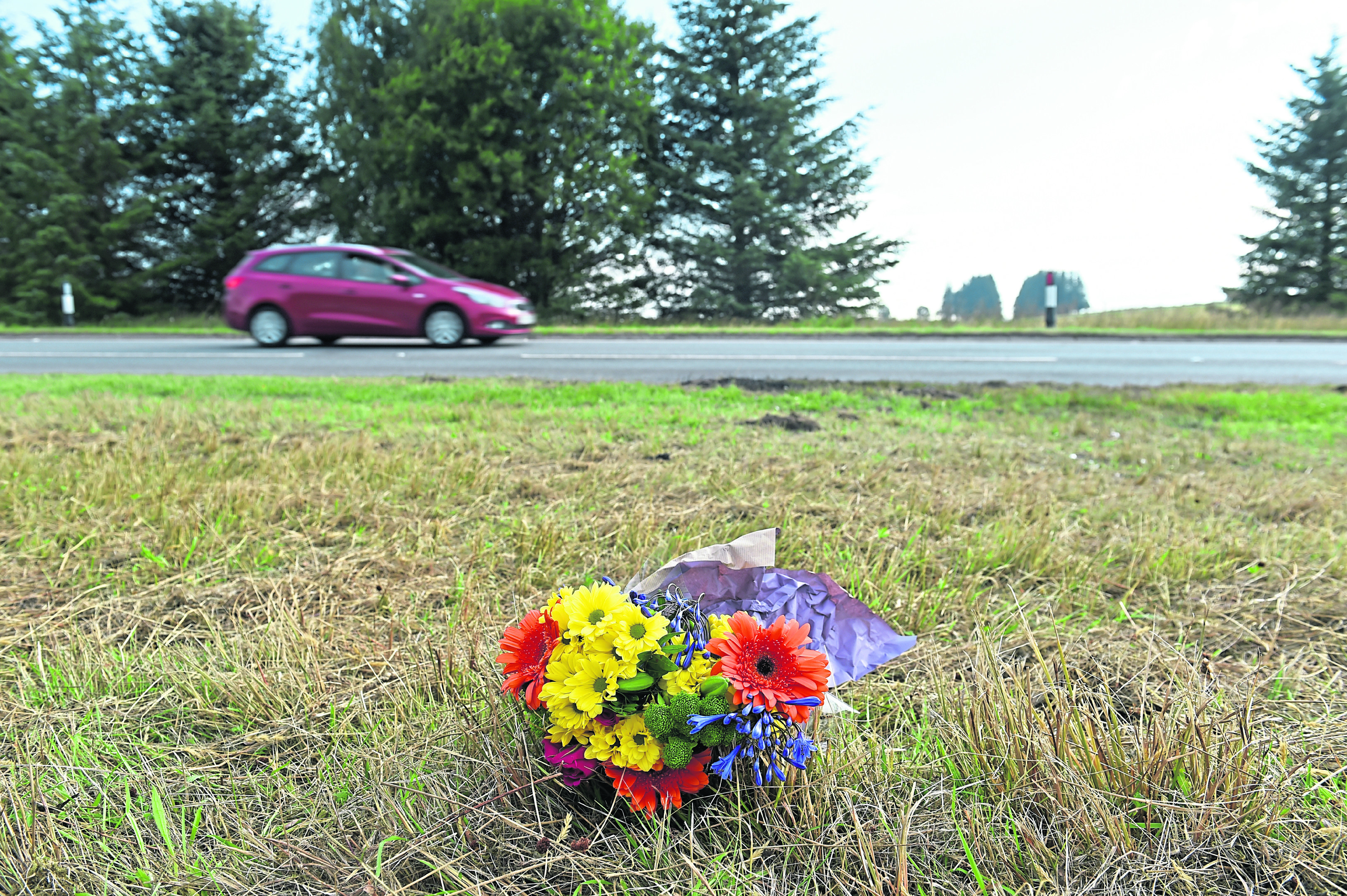 Flowers laid at the site where five people died in a car and minibus accident on the A96, between Keith and Huntly. 
Picture by Kenny Elrick
