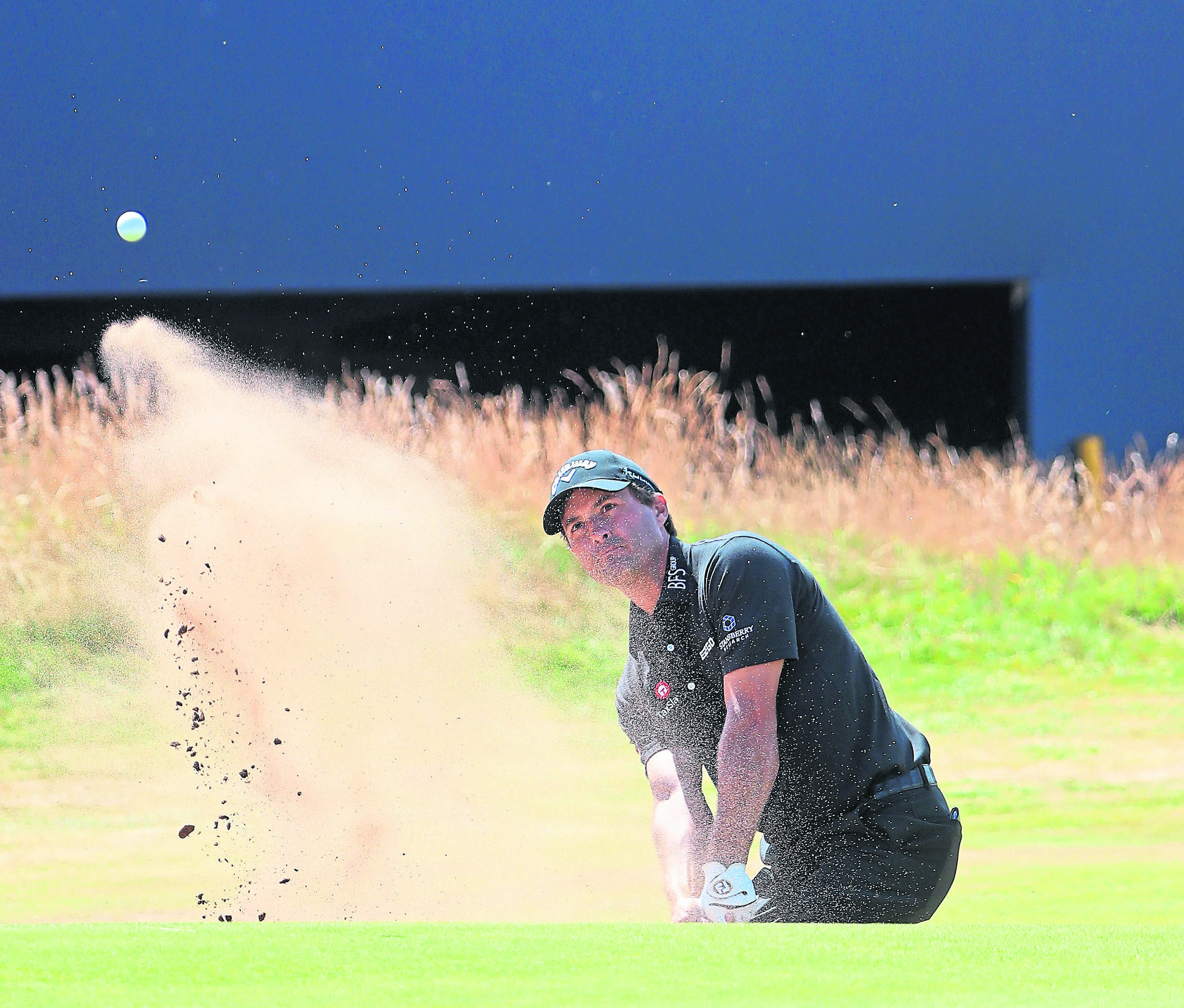Kevin Kisner hits a bunker shot on the 18th hole at the 147th Open Championship at Carnoustie Golf Club.