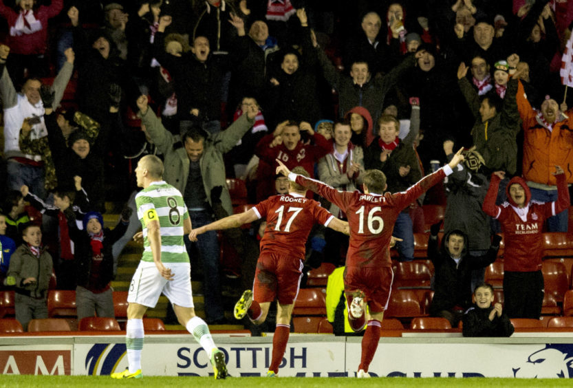 Rooney celebrates after scoring his side's second goal of the game against Celtic in February 2014.