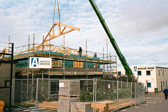 Trusses being lowered onto the "Old Gatehouse" at Anderson Construction's Quarry Road Headquarters to create additional office accommodation for lease.