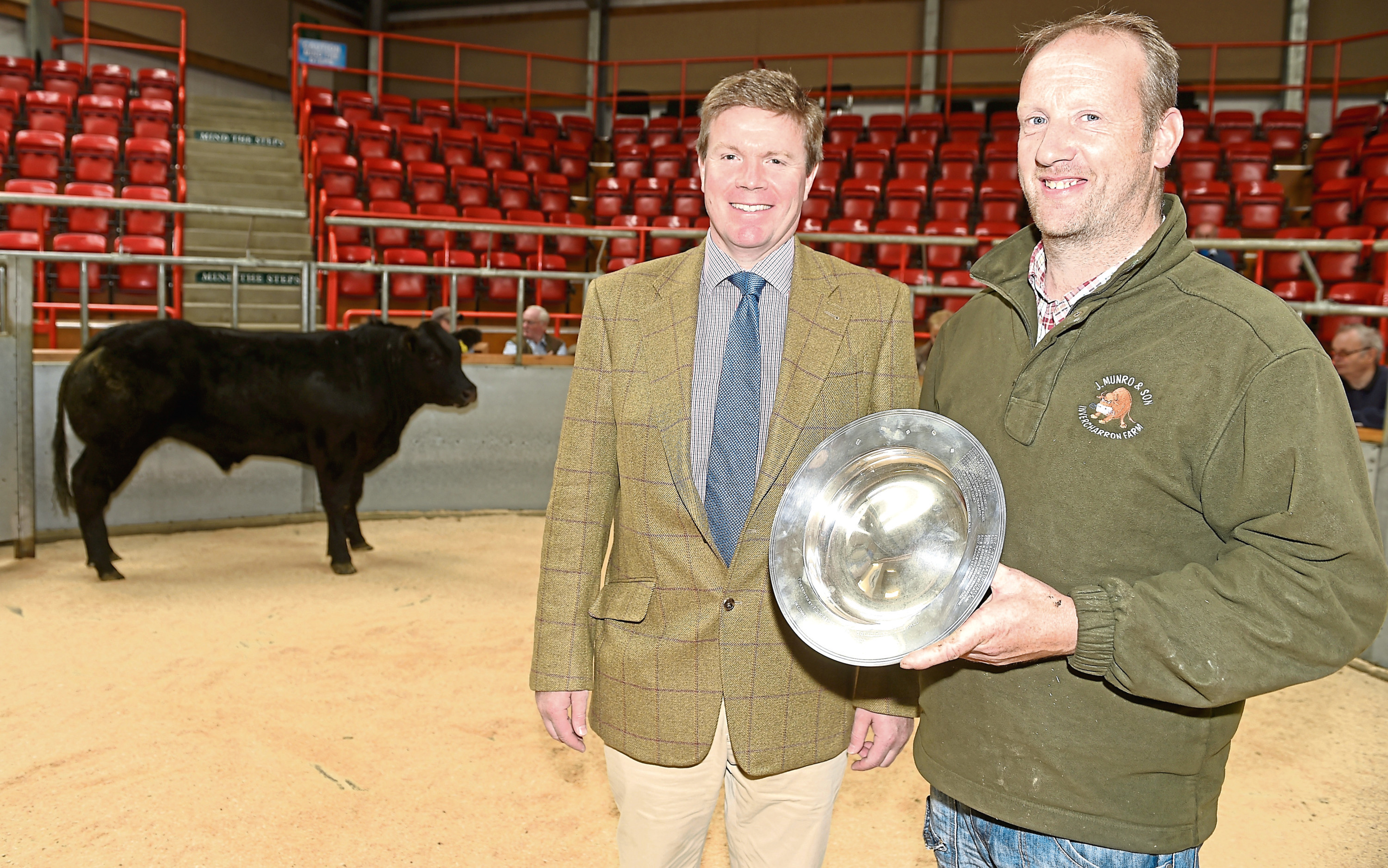 The winning animal from Mark Munro (right) of Invercharron Mains, Ardgay, and Martin Mackay of Brodies LLP, sponsors, on the left.