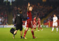 Sam Cosgrove salutes the Aberdeen fans during his impressive performance in the first leg against Burnley.