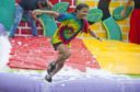 Competitors competed across a series of inflatable challenges which had been covered in foamy water.