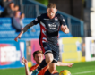 Dundee United’s Sam Stanton tries to halt Declan McManus